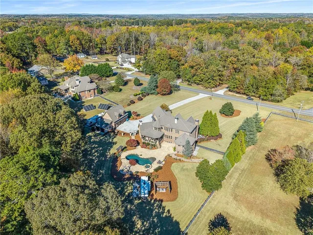 a kitchen with stainless steel appliances granite countertop a sink a stove and a wooden floors