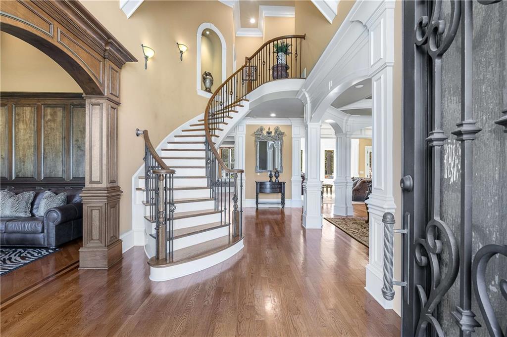 2145 Jones Phillips Road Dacula, GA 30019 - Photo 21 of 98 a view of a hallway with wooden floor and staircase