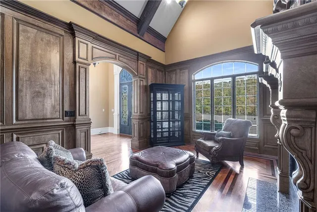 a spacious bedroom with a bed and a chandelier