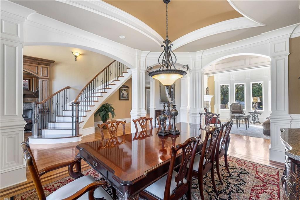 2145 Jones Phillips Road Dacula, GA 30019 - Photo 26 of 98 a view of a dining room with furniture a chandelier and wooden floor