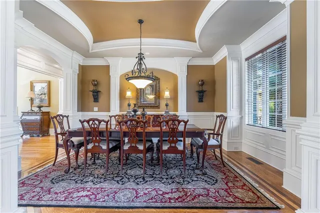 a large white kitchen with a large window