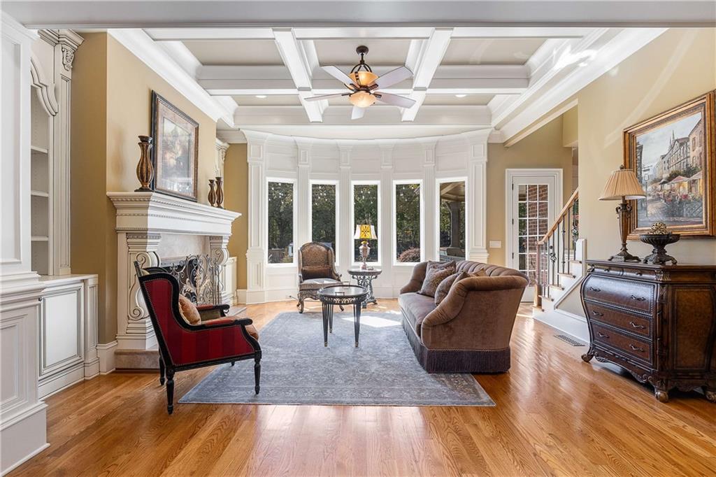 2145 Jones Phillips Road Dacula, GA 30019 - Photo 29 of 98 a living room with furniture a fireplace and wooden floor