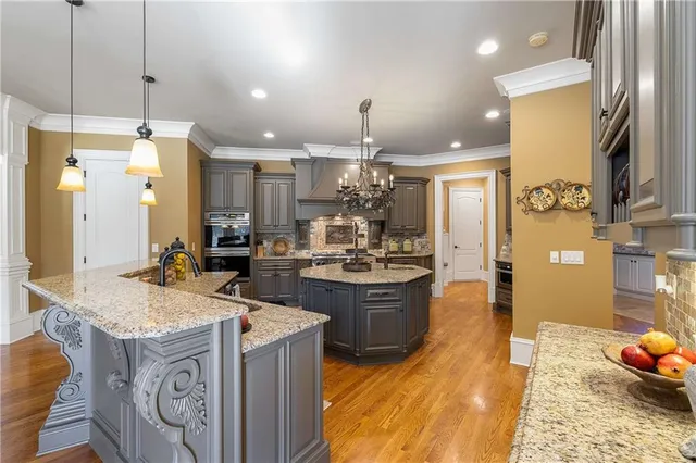 a bathroom with a granite countertop double vanity sink and mirror