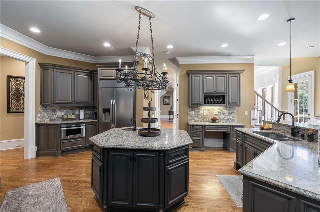 2145 Jones Phillips Road Dacula, GA 30019 - Photo 35 of 98 a kitchen with stainless steel appliances granite countertop a sink stove and refrigerator