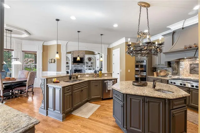 a living room with furniture chandelier and a flat screen tv