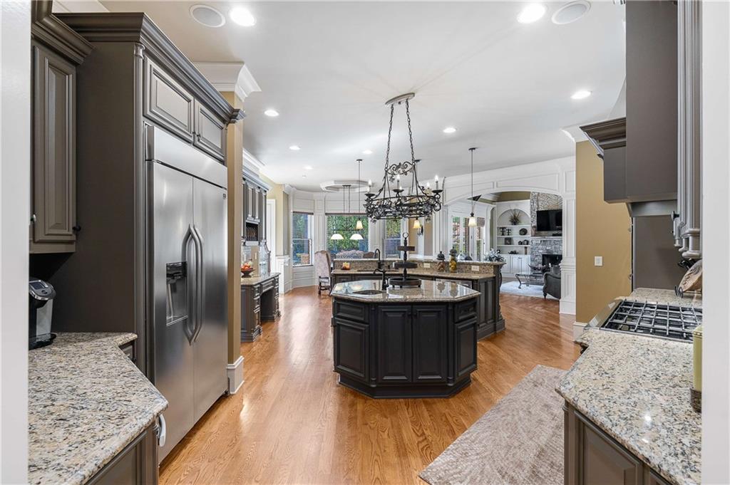 2145 Jones Phillips Road Dacula, GA 30019 - Photo 36 of 98 a living room with stainless steel appliances granite countertop furniture and a wooden floor