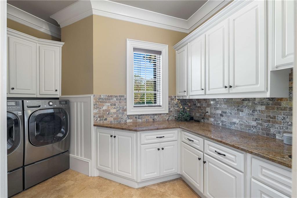 2145 Jones Phillips Road Dacula, GA 30019 - Photo 41 of 98 a kitchen with granite countertop white cabinets and a sink