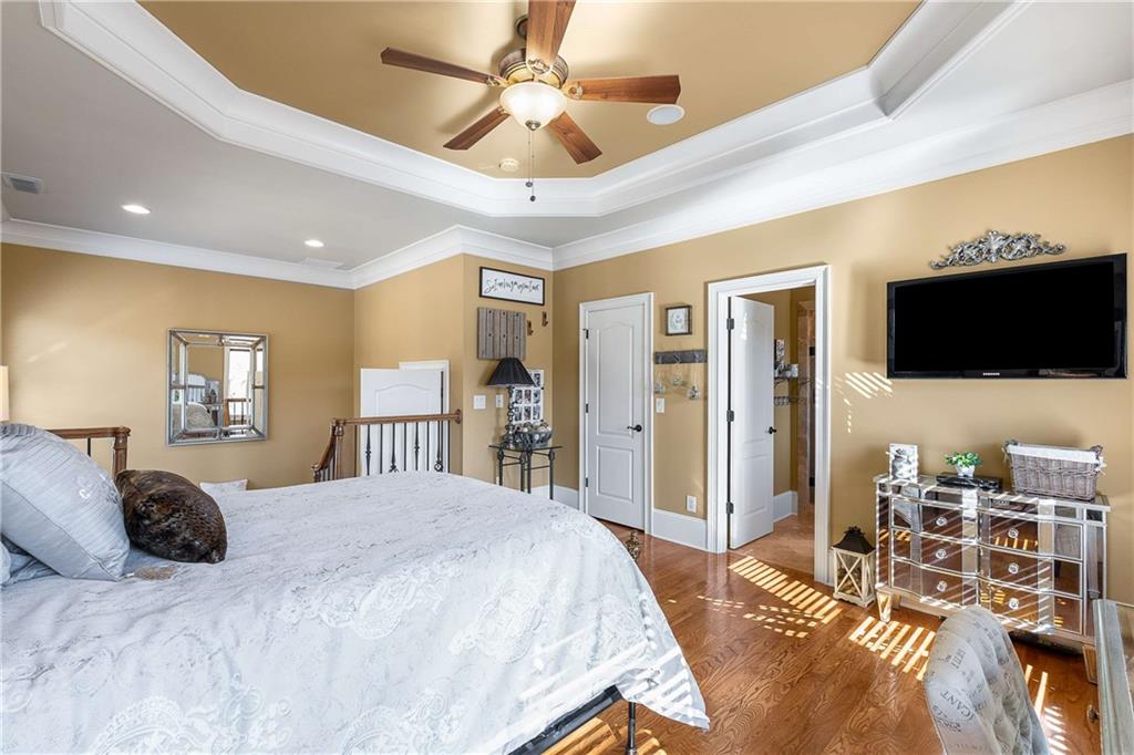 2145 Jones Phillips Road Dacula, GA 30019 - Photo 52 of 98 a bedroom with a bed and a flat screen tv