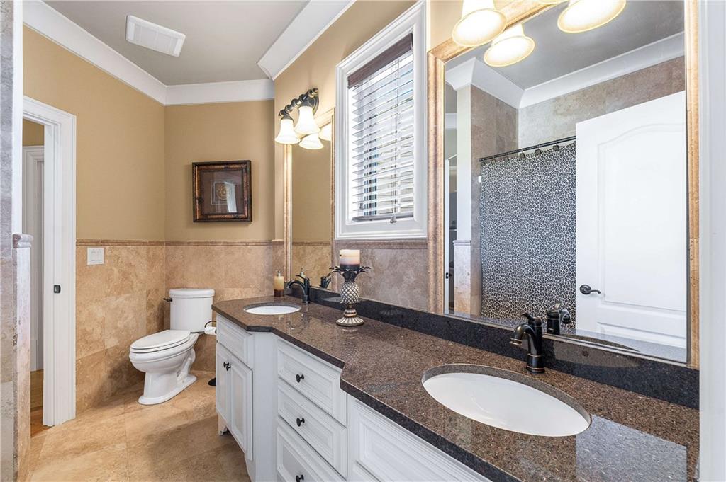2145 Jones Phillips Road Dacula, GA 30019 - Photo 55 of 98 a bathroom with a granite countertop sink and a mirror