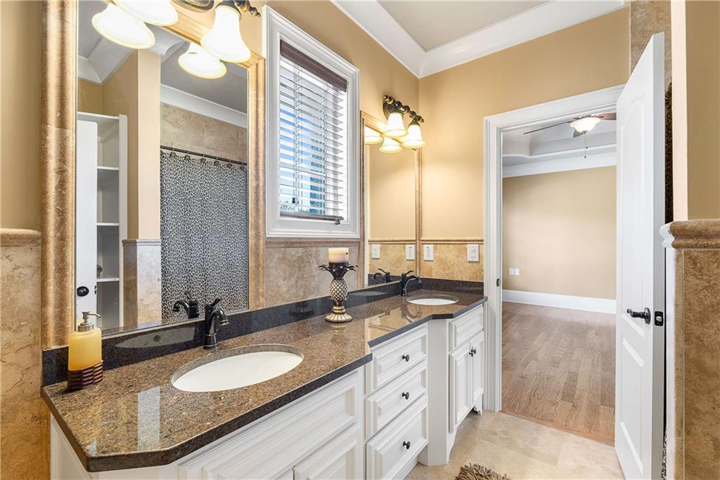 2145 Jones Phillips Road Dacula, GA 30019 - Photo 56 of 98 a bathroom with a granite countertop double vanity sink and mirror