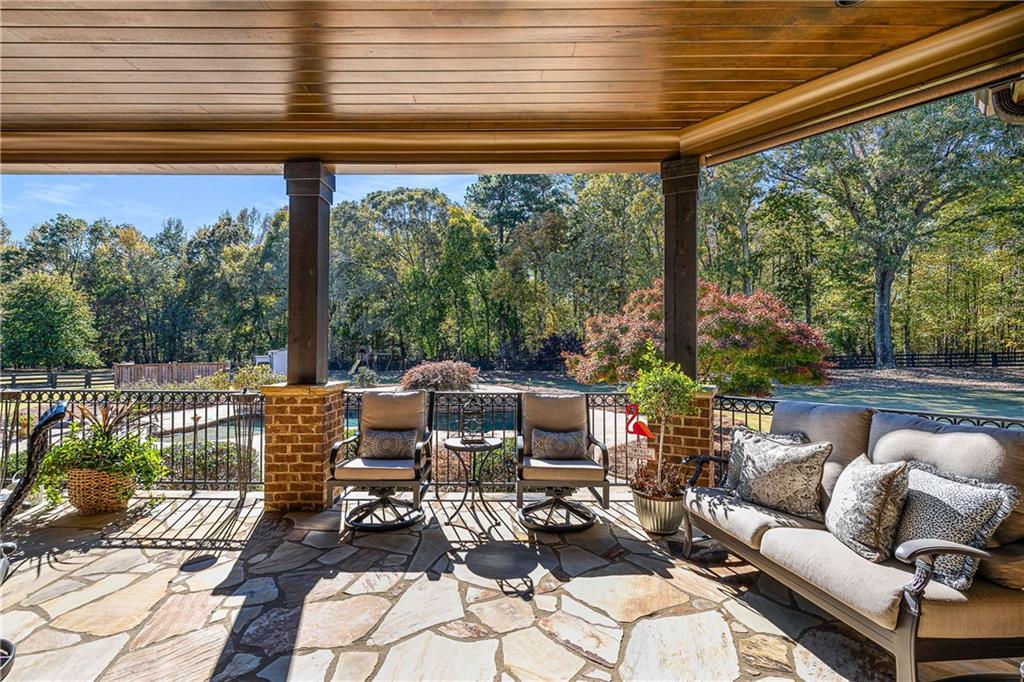 2145 Jones Phillips Road Dacula, GA 30019 - Photo 75 of 98 a outdoor living space with patio furniture and a potted plant