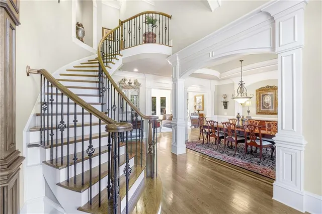 a view of a hallway with wooden floor and staircase