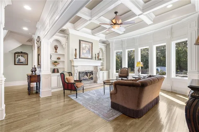 a living room with fireplace furniture and a chandelier