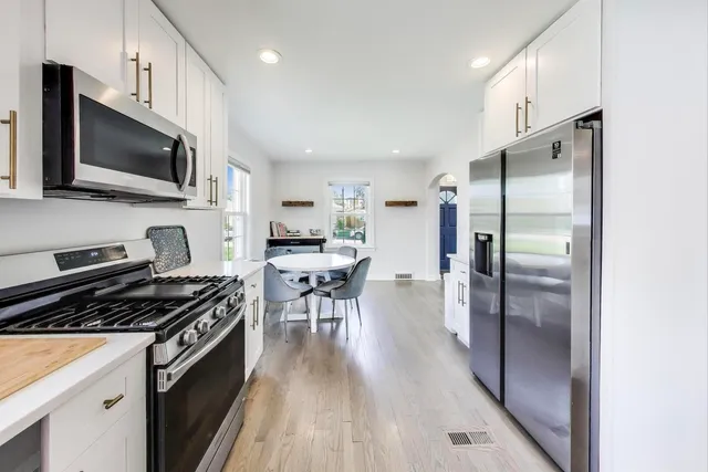 a kitchen with stainless steel appliances a stove a sink and a refrigerator