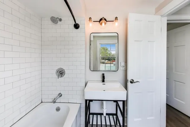 a bathroom with a sink a bathtub and a shower