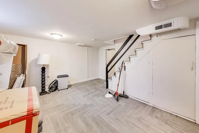 a view of a livingroom with wooden floor and stairs