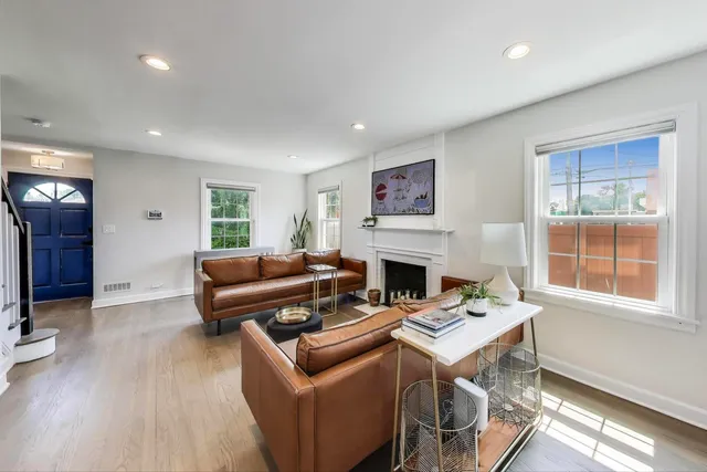 a living room with furniture a fireplace and a table