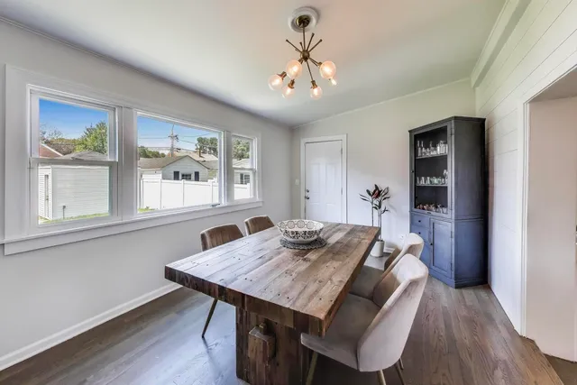 a view of a dining room with furniture window and wooden floor