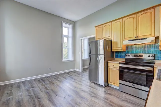 a kitchen with stainless steel appliances a stove and a refrigerator