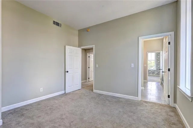 an empty room that has a wooden cupboard