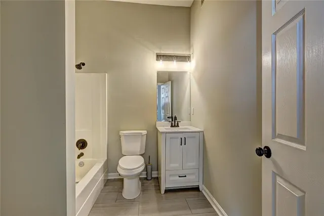 a white toilet sitting next to a bathroom sink