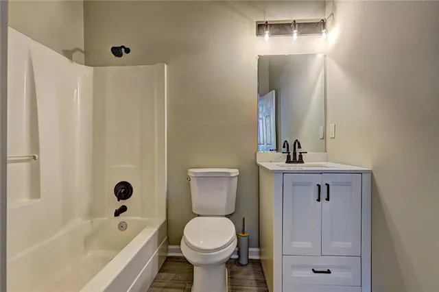 a bathroom with a toilet sink and shower