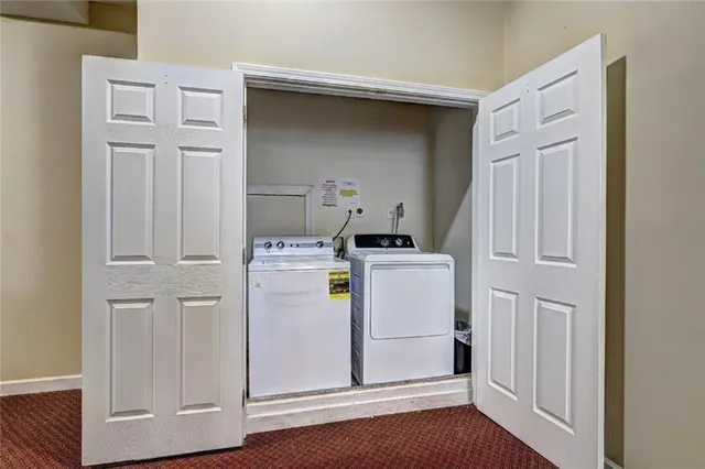 a utility room with closet dryer and washer