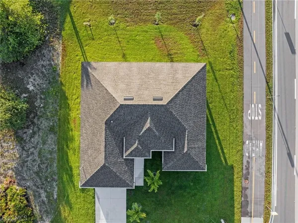 an aerial view of a house with a yard