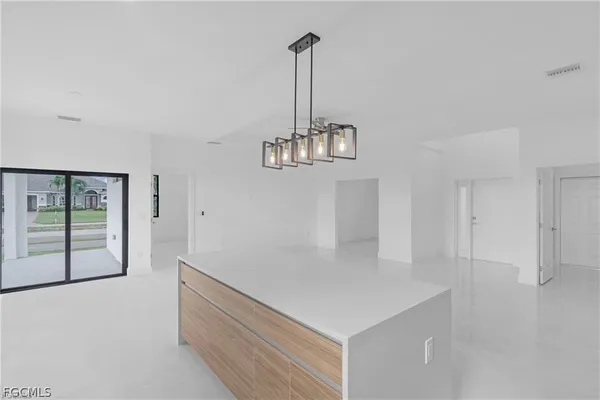 a view of a room with wooden floor and windows