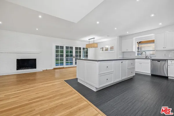 a kitchen with stainless steel appliances granite countertop a sink and cabinets