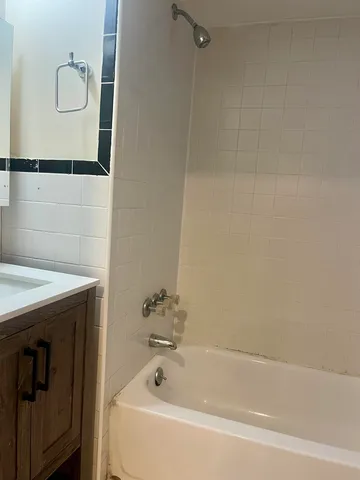a kitchen with stainless steel appliances white cabinets and a stove top oven