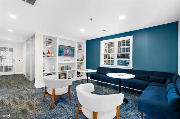 a room with wooden floor pool table and chairs