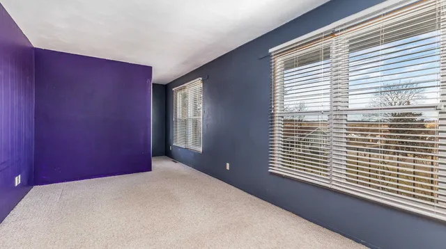 a view of a livingroom with an empty space and a window