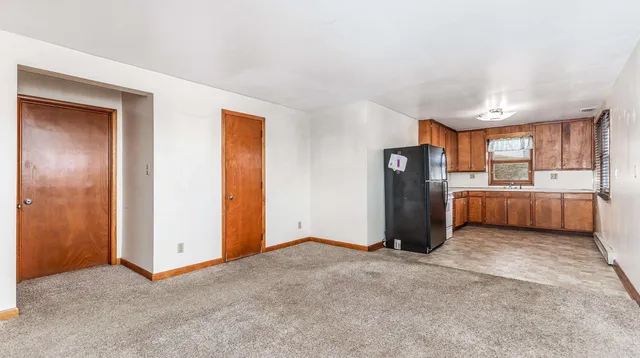 an empty room with closet and windows