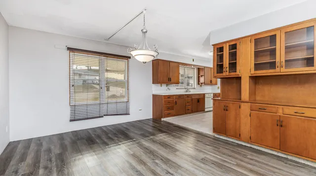 a kitchen with stainless steel appliances granite countertop a stove a sink and a refrigerator with white cabinets
