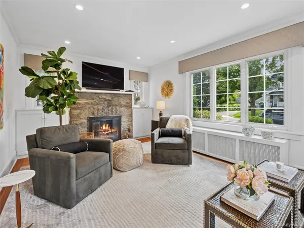 a living room with furniture fireplace and window