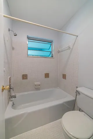 a white bath tub sitting next to a white toilet