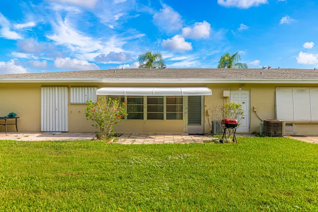 a front view of a house with a garden and plants