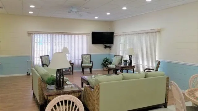 a room with pool table and windows