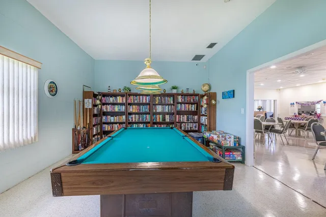 a view of a patio with table and chairs and potted plants