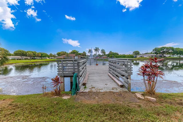 a view of a balcony with dining table and chairs