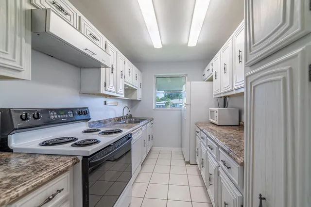 a kitchen with stainless steel appliances granite countertop a stove and a cabinets