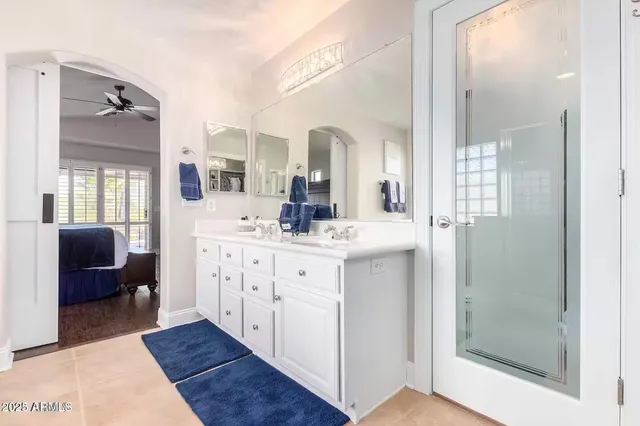 a bathroom with a double vanity sink mirror and shower