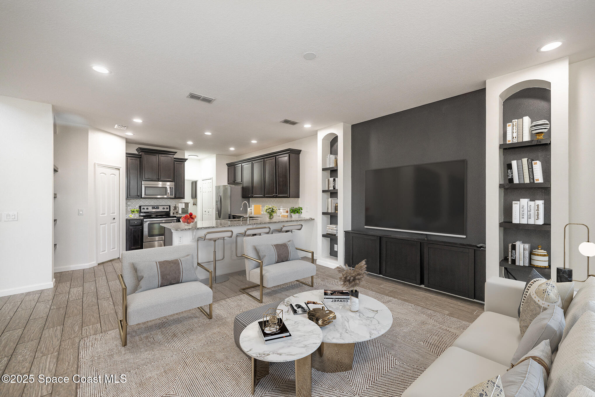 3226 Arden Circle Melbourne, FL 32934 - Photo 12 of 43 a living room with furniture kitchen view and a refrigerator