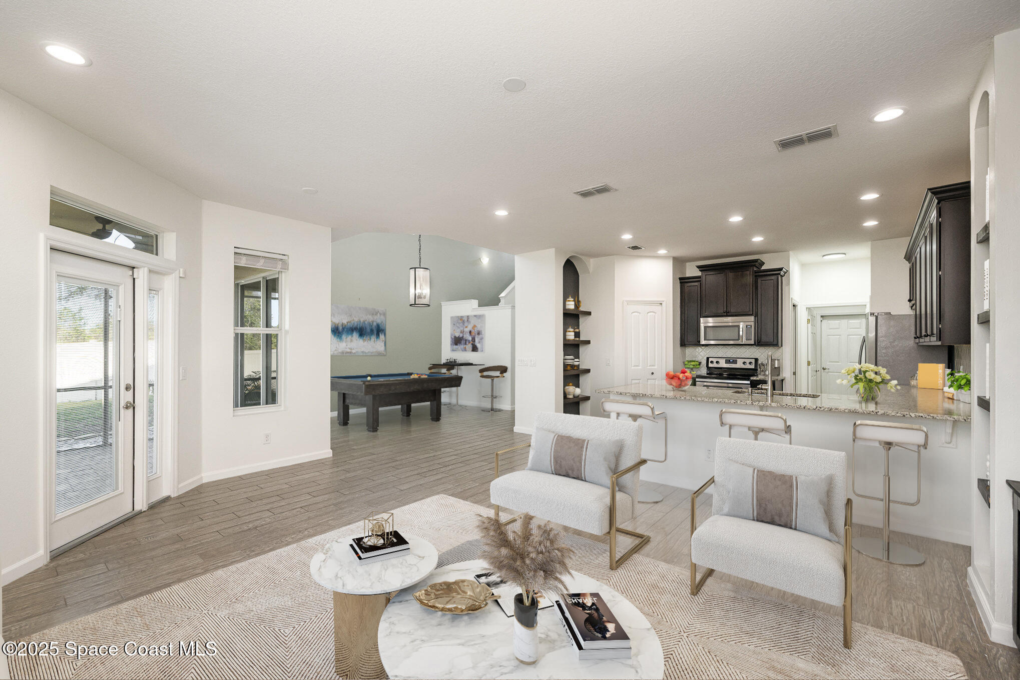 3226 Arden Circle Melbourne, FL 32934 - Photo 13 of 43 a living room with furniture and a dining table with kitchen view