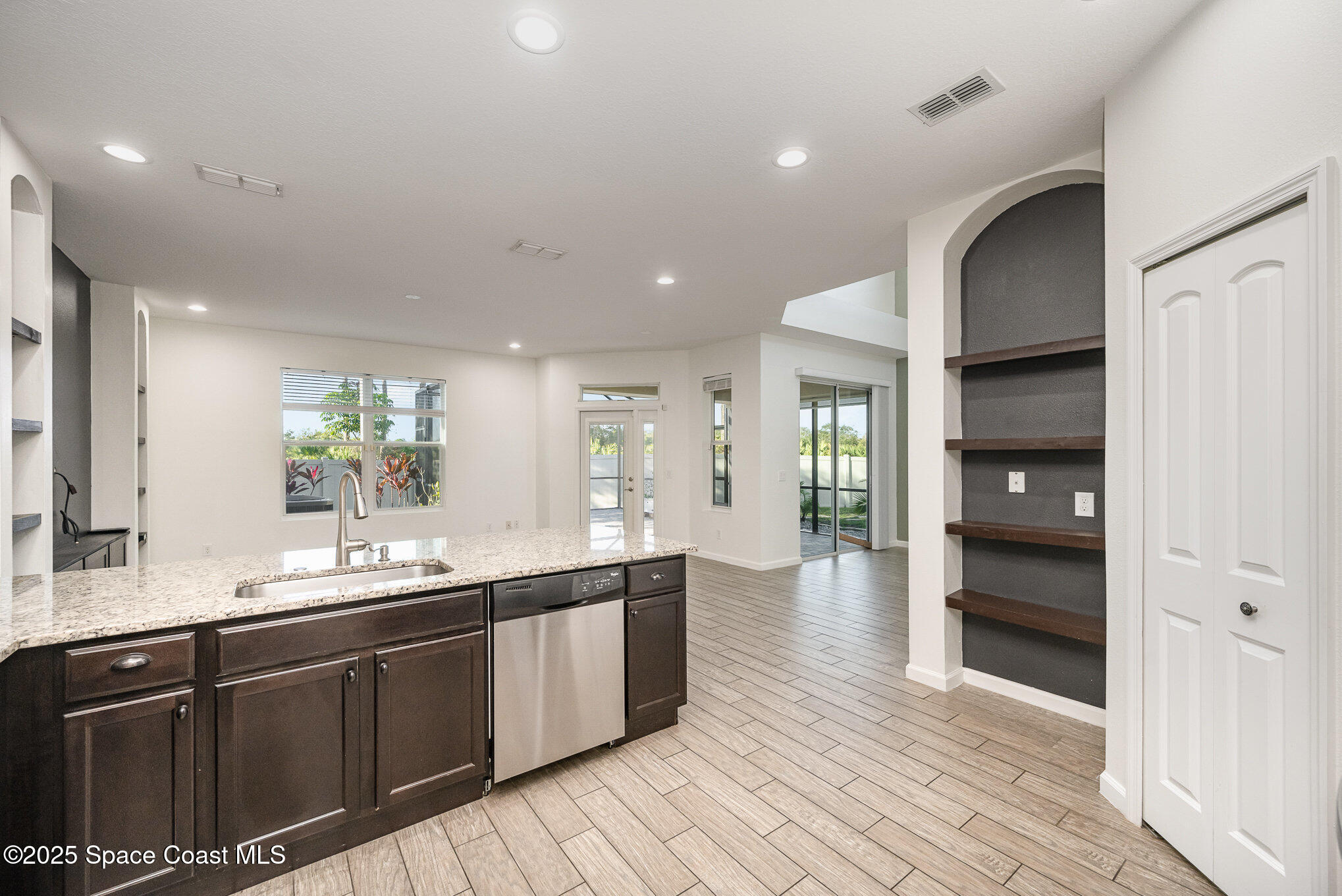 3226 Arden Circle Melbourne, FL 32934 - Photo 15 of 43 a large kitchen with stainless steel appliances a large counter top a sink and a refrigerator