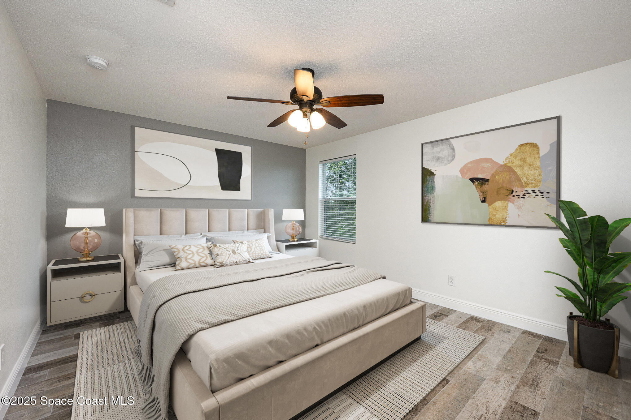 3226 Arden Circle Melbourne, FL 32934 - Photo 21 of 43 a bedroom with a large bed and a chandelier