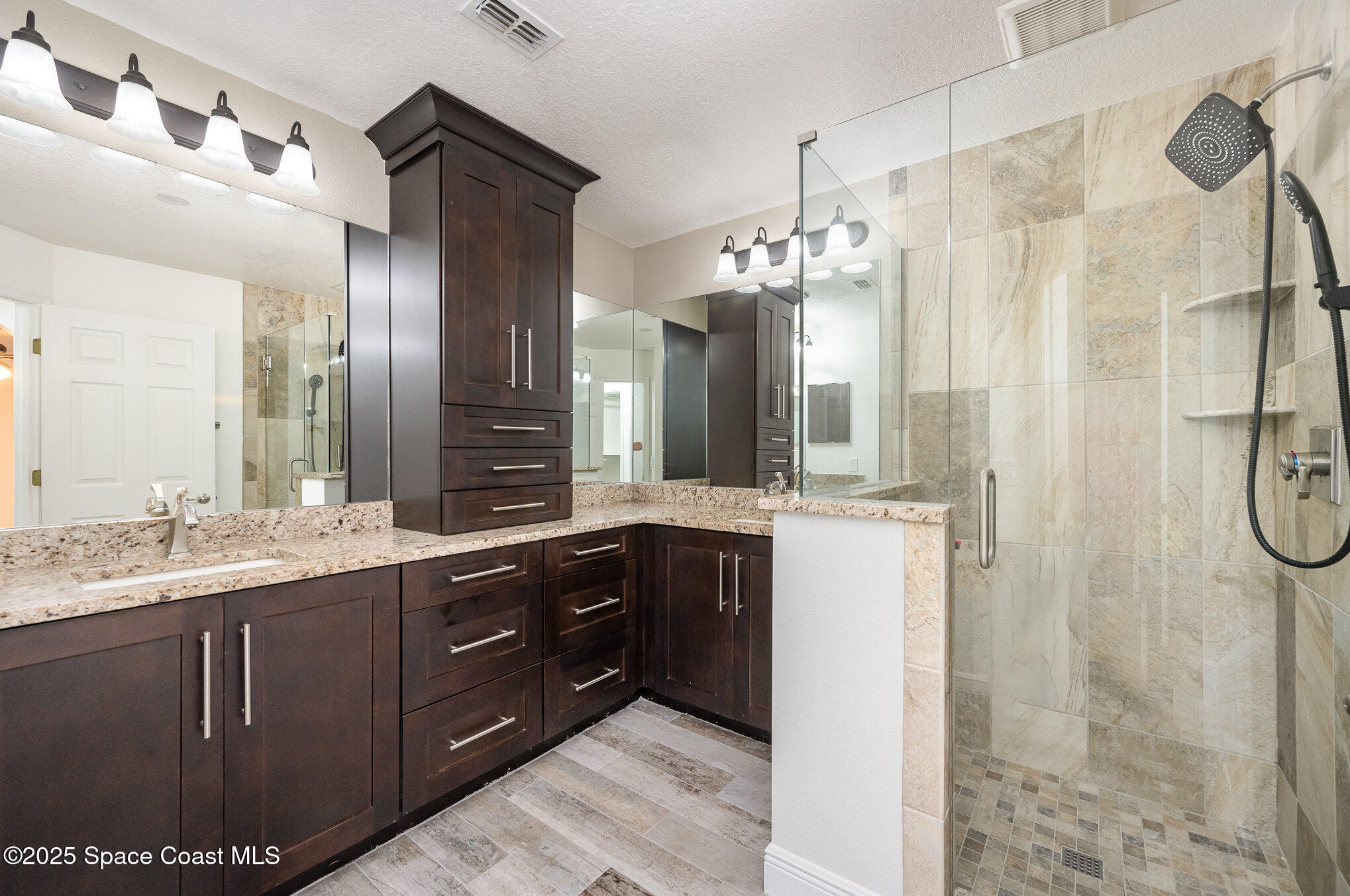 3226 Arden Circle Melbourne, FL 32934 - Photo 23 of 43 a spacious bathroom with a double vanity sink mirror and shower
