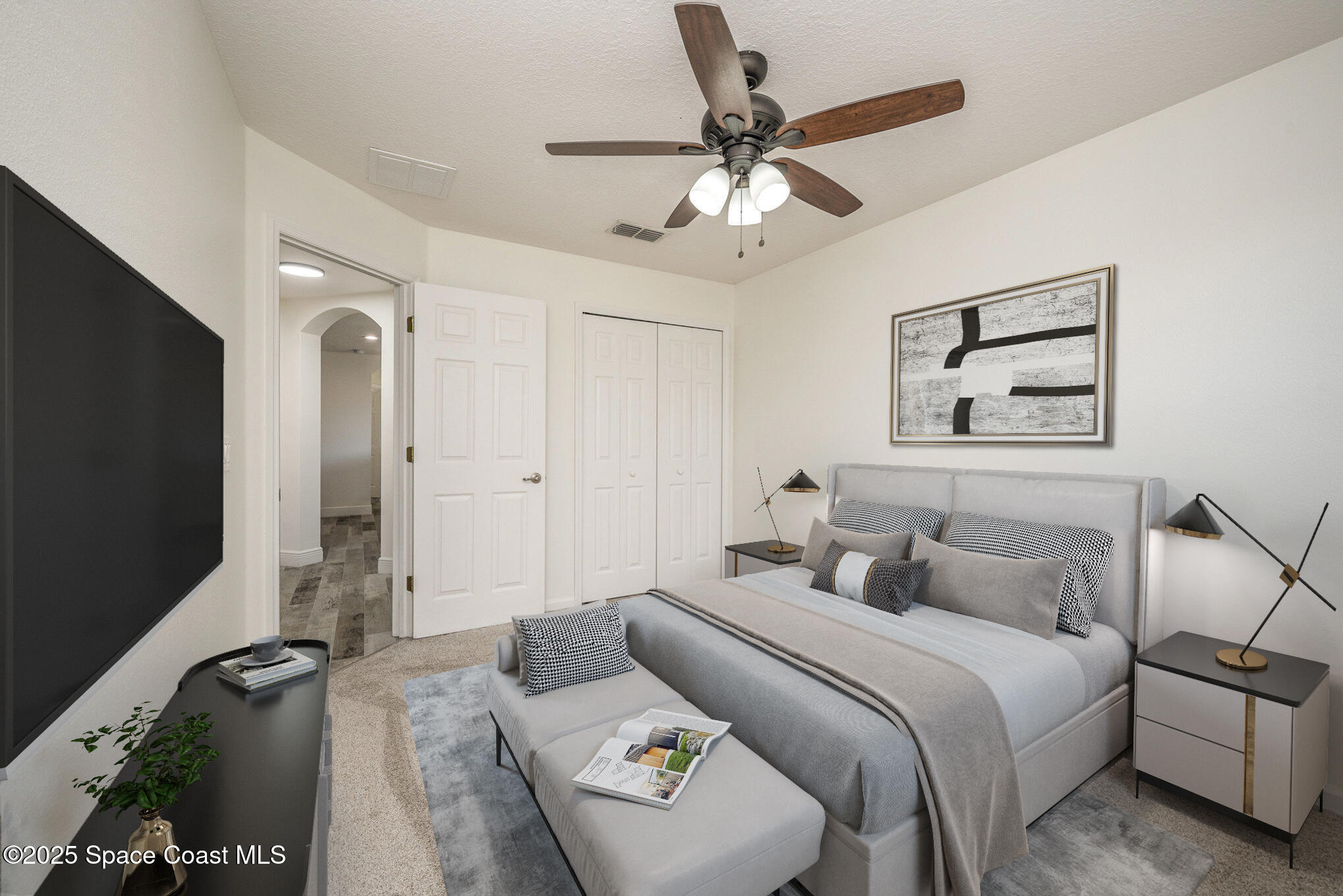 3226 Arden Circle Melbourne, FL 32934 - Photo 27 of 43 a bedroom with a bed and a chandelier