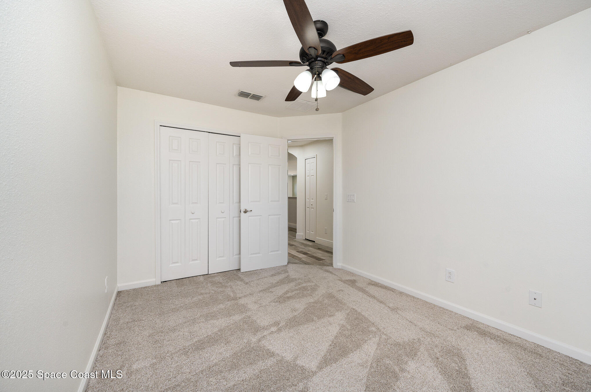 3226 Arden Circle Melbourne, FL 32934 - Photo 29 of 43 an empty room with a ceiling fan and fan